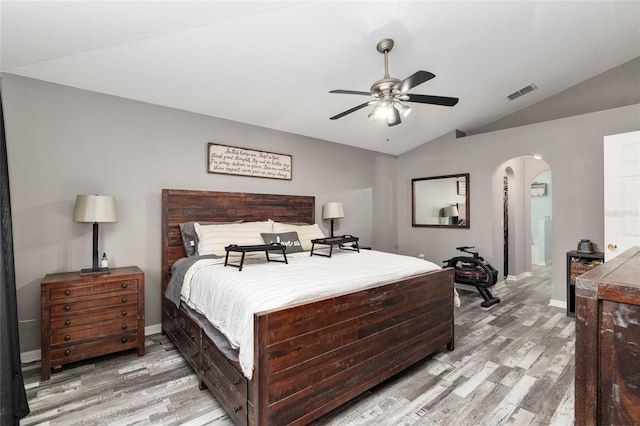 bedroom featuring ceiling fan, light hardwood / wood-style flooring, and lofted ceiling