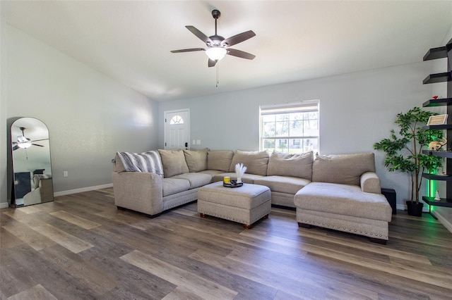 living room with ceiling fan, dark hardwood / wood-style flooring, and vaulted ceiling