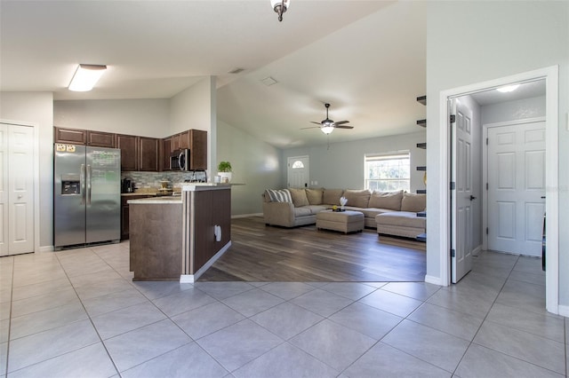 17023 SW 41st Avenue Rd, Ocala, FL 34473 - kitchen featuring dark brown cabinetry, ceiling fan, light hardwood / wood-style flooring, vaulted ceiling, and appliances with stainless steel finishes