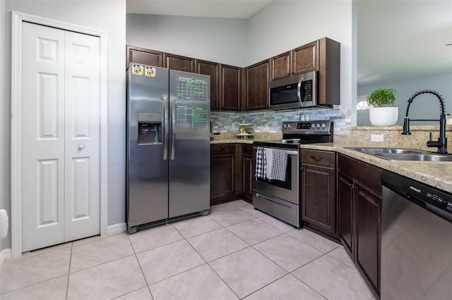 17023 SW 41st Avenue Rd, Ocala, FL 34473 - kitchen with decorative backsplash, stainless steel appliances, vaulted ceiling, sink, and light tile patterned floors