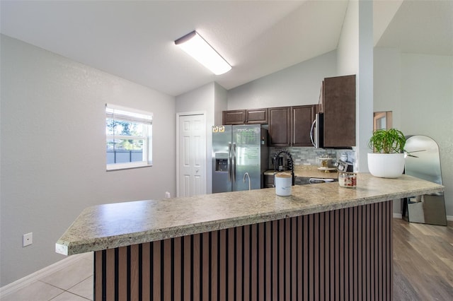 17023 SW 41st Avenue Rd, Ocala, FL 34473 - kitchen with light hardwood / wood-style flooring, kitchen peninsula, stainless steel appliances, and vaulted ceiling