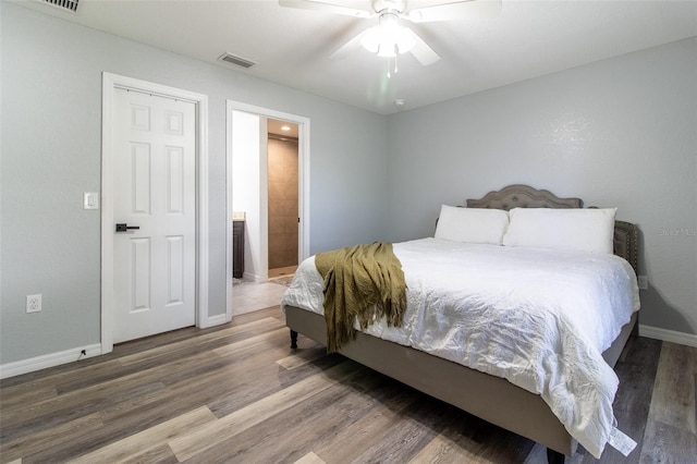 17023 SW 41st Avenue Rd, Ocala, FL 34473 - bedroom with connected bathroom, ceiling fan, and hardwood / wood-style flooring