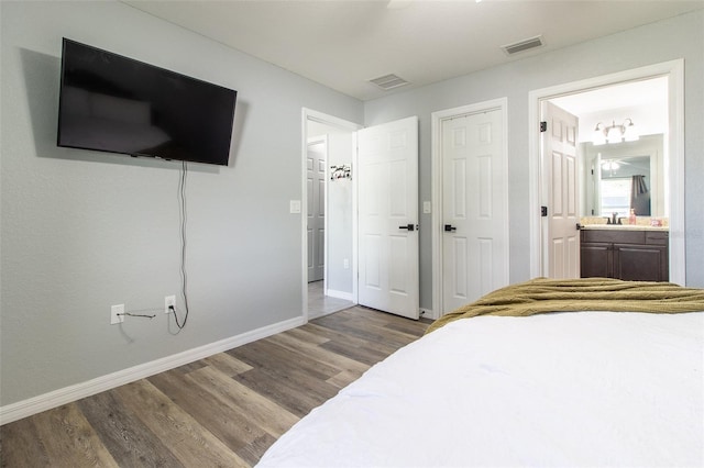17023 SW 41st Avenue Rd, Ocala, FL 34473 - bedroom featuring ensuite bathroom, hardwood / wood-style flooring, and sink