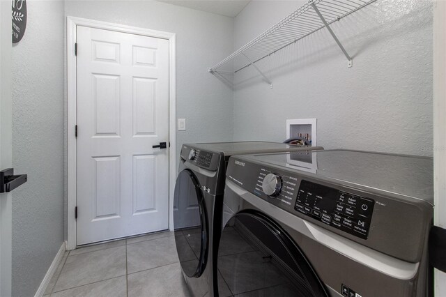 17023 SW 41st Avenue Rd, Ocala, FL 34473 - laundry area with light tile patterned floors and washer and dryer