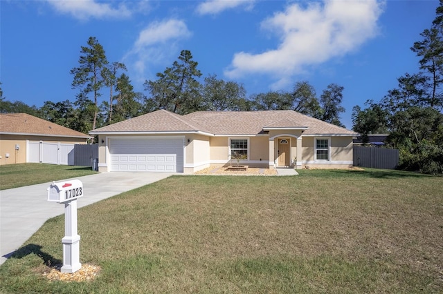 17023 SW 41st Avenue Rd, Ocala, FL 34473 - view of front of home with a garage and a front lawn