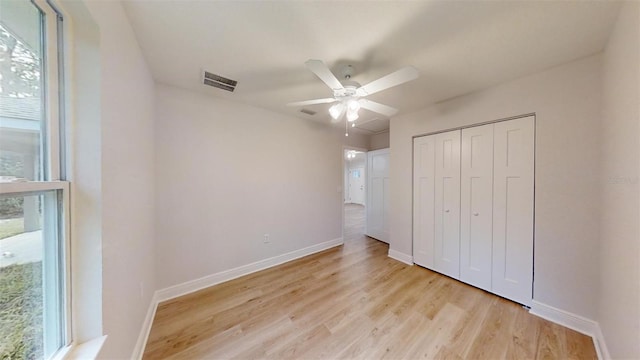 unfurnished bedroom featuring a closet, ceiling fan, and light hardwood / wood-style flooring