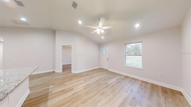 unfurnished living room with ceiling fan, light hardwood / wood-style flooring, and vaulted ceiling