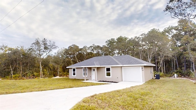 single story home with a front yard, a garage, and central AC unit