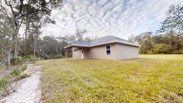 view of home's exterior with a lawn