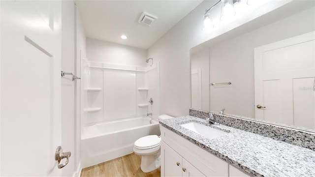 full bathroom featuring vanity, hardwood / wood-style floors, shower / bathing tub combination, and toilet