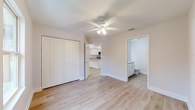 unfurnished bedroom with light wood-type flooring, multiple windows, and ceiling fan