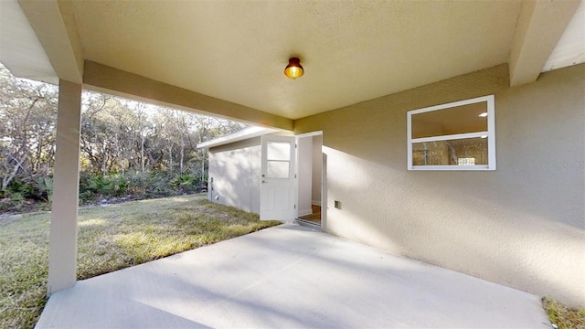 view of patio with a storage unit