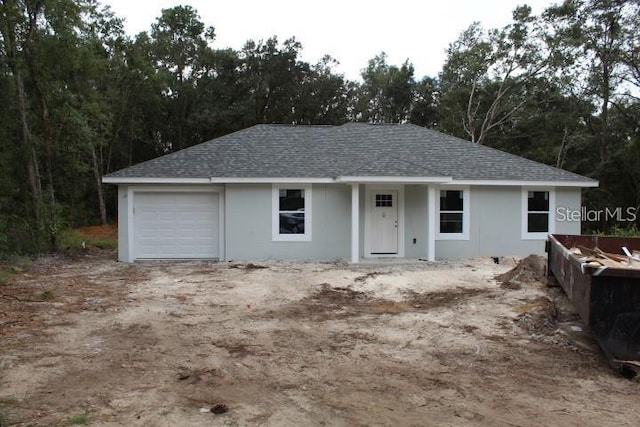 single story home featuring a garage