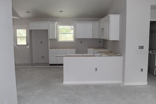 kitchen with white cabinets and a wealth of natural light