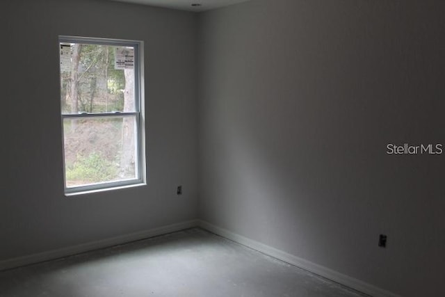 unfurnished room with a healthy amount of sunlight and concrete floors