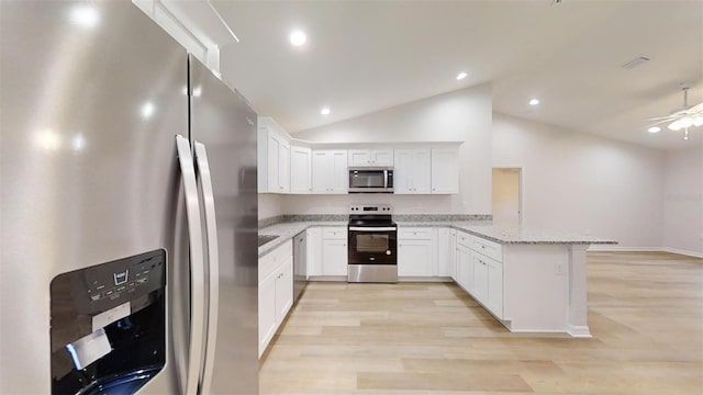 kitchen with white cabinetry, light stone countertops, stainless steel appliances, and kitchen peninsula