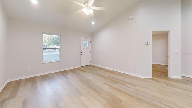 unfurnished room with high vaulted ceiling, ceiling fan, and light hardwood / wood-style flooring