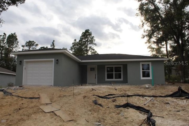 277 Oak Lane Cir, Ocala, FL 34472 - ranch-style home featuring an attached garage, stucco siding, and driveway