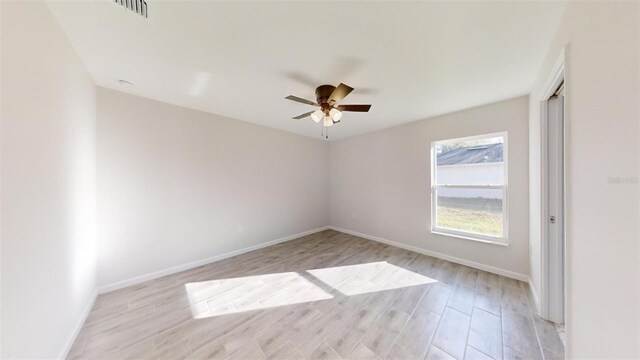 empty room featuring ceiling fan and light hardwood / wood-style flooring