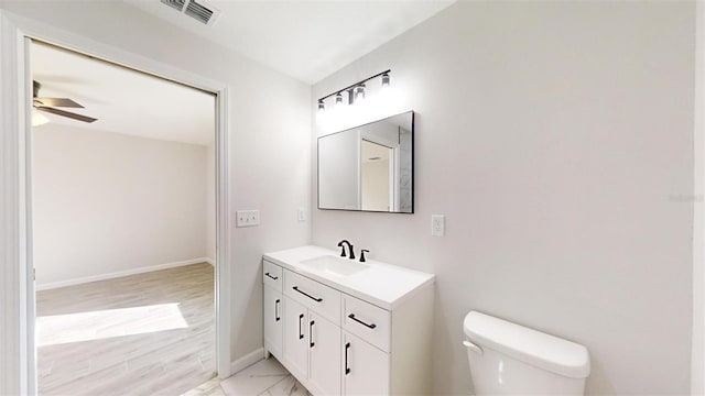 bathroom with ceiling fan, toilet, and vanity