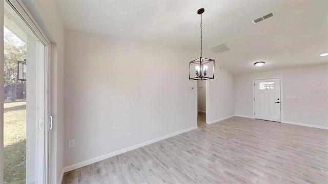 interior space with light hardwood / wood-style flooring and a notable chandelier