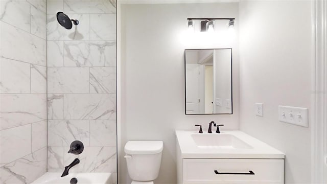 full bathroom featuring tiled shower / bath combo, toilet, and vanity