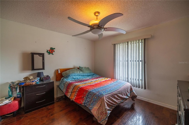 bedroom featuring dark hardwood / wood-style floors, ceiling fan, and a textured ceiling