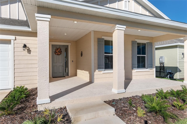 view of exterior entry featuring covered porch