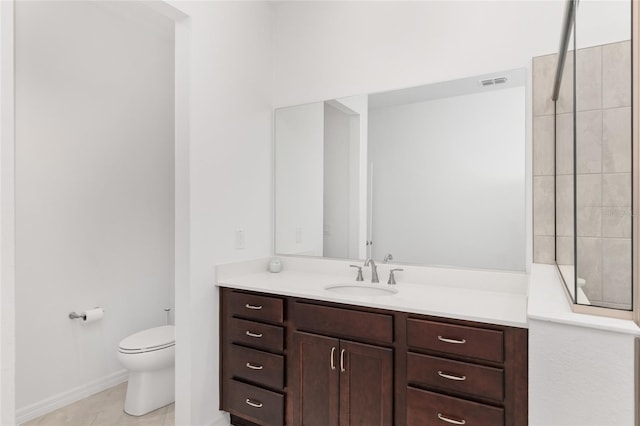 bathroom featuring toilet, tile patterned flooring, and vanity