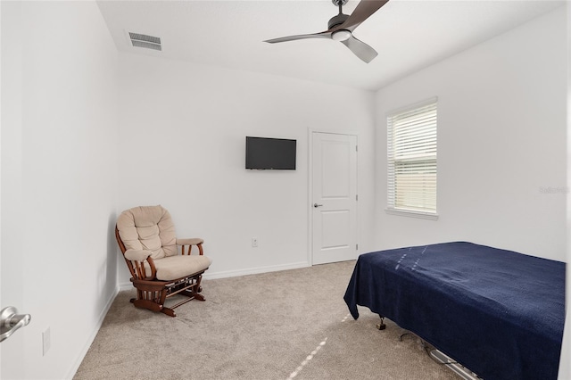 bedroom featuring light colored carpet and ceiling fan