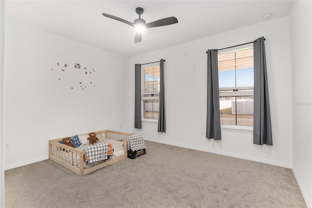 interior space with ceiling fan and carpet floors