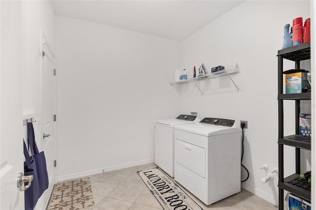 washroom featuring light tile patterned flooring and washing machine and clothes dryer