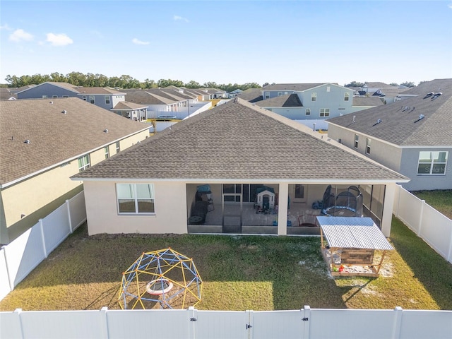 rear view of house with a lawn