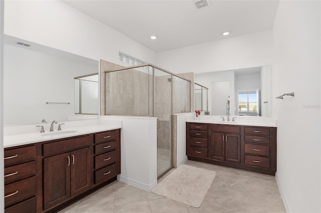 bathroom featuring walk in shower, vanity, and tile patterned floors