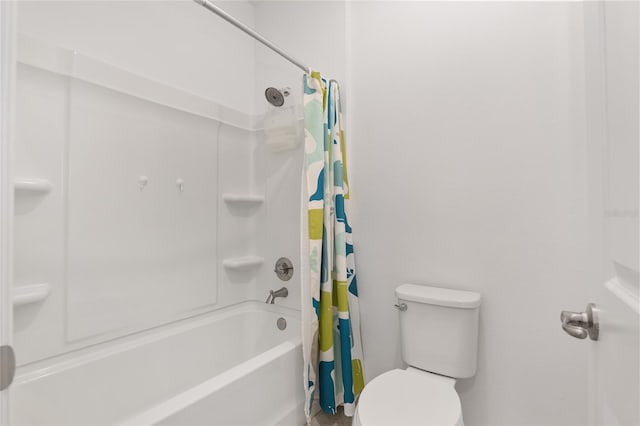 bathroom with shower / bath combo and toilet