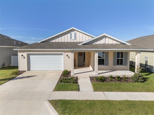 single story home with a front yard, a garage, and a porch