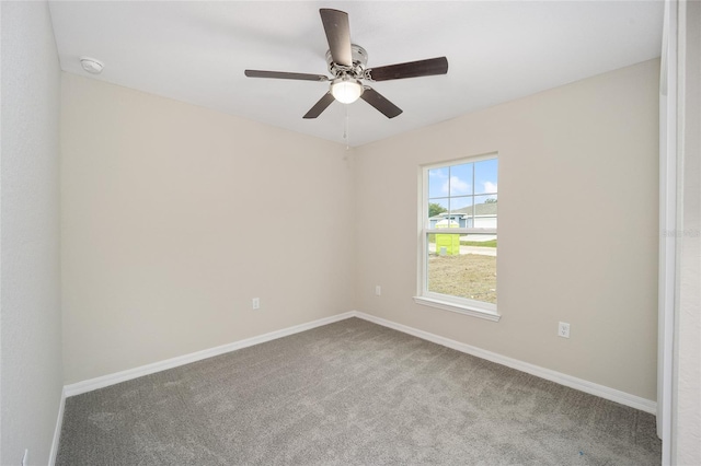 unfurnished room with carpet, a ceiling fan, and baseboards