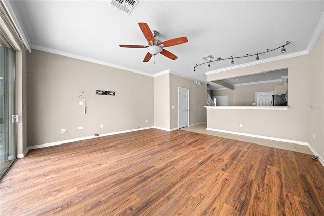 unfurnished living room featuring ceiling fan, rail lighting, light hardwood / wood-style flooring, crown molding, and a textured ceiling