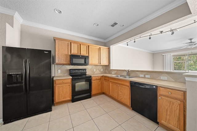 kitchen with black appliances, ornamental molding, a textured ceiling, and light tile patterned floors