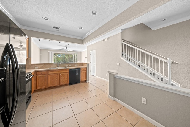 kitchen featuring a textured ceiling, sink, ornamental molding, and black appliances