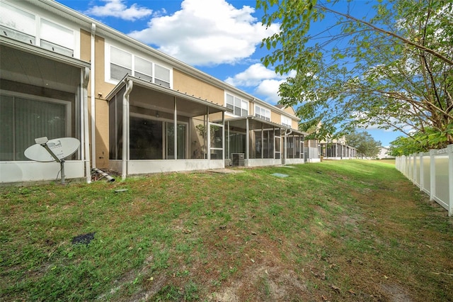 rear view of house with a yard