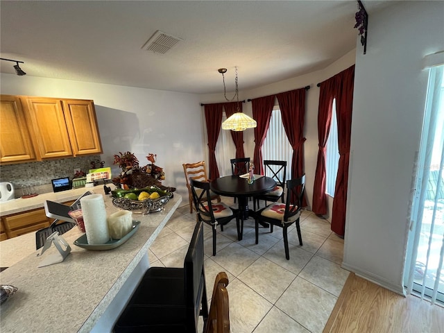 dining space featuring light hardwood / wood-style flooring and a healthy amount of sunlight