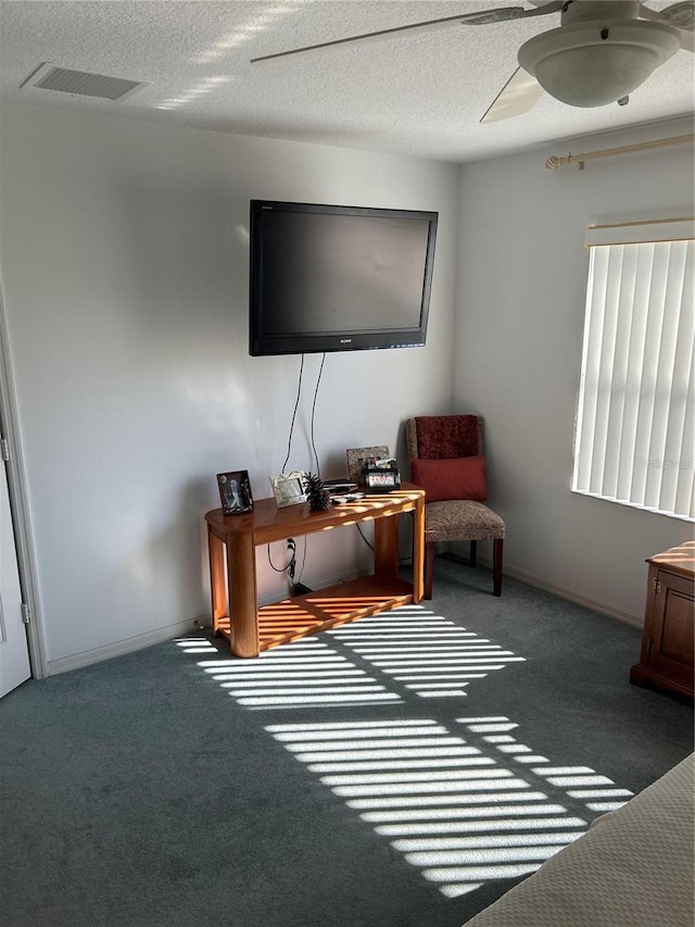 office area with ceiling fan, carpet floors, and a textured ceiling