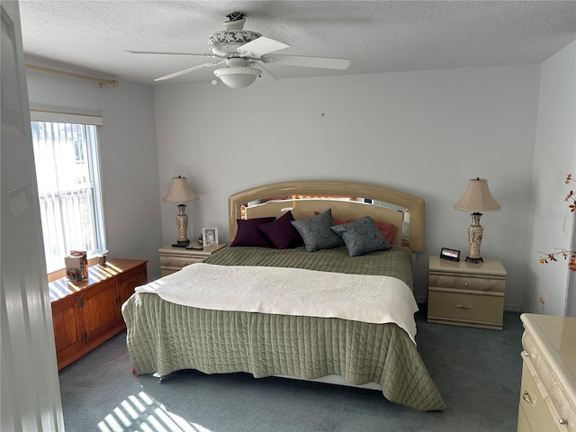 carpeted bedroom with a textured ceiling and ceiling fan