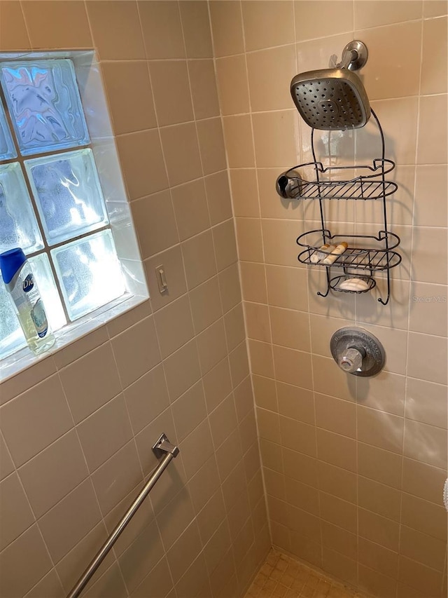 bathroom featuring a tile shower and plenty of natural light