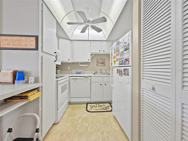 kitchen with white appliances, sink, vaulted ceiling, ceiling fan, and white cabinetry