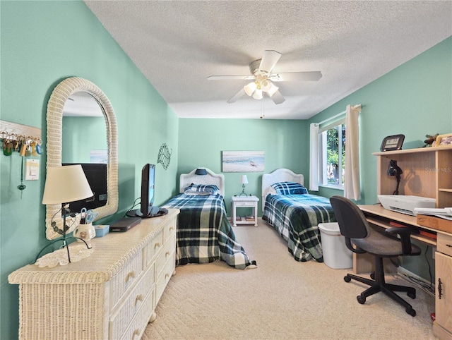 carpeted bedroom with ceiling fan and a textured ceiling