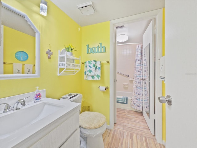 full bathroom featuring shower / tub combo, vanity, hardwood / wood-style flooring, and toilet