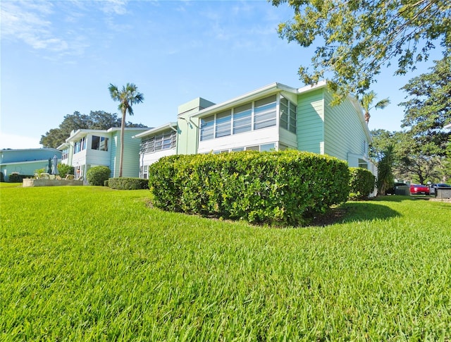 view of home's exterior with a yard