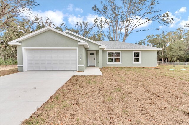 ranch-style house with a front yard and a garage